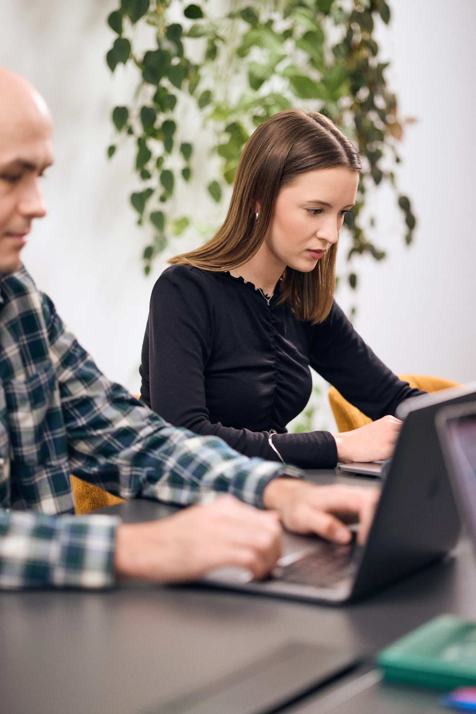 Two mohi.to team members reviewing work on a laptop