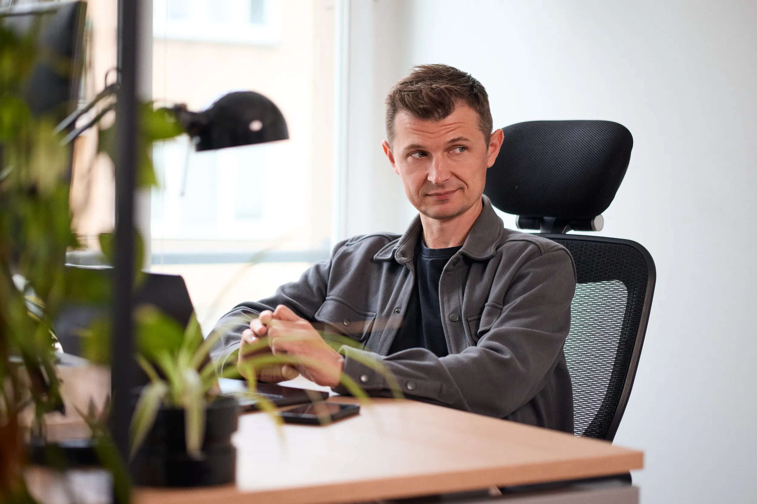 A mohi.to team member at their desk, mid-thought